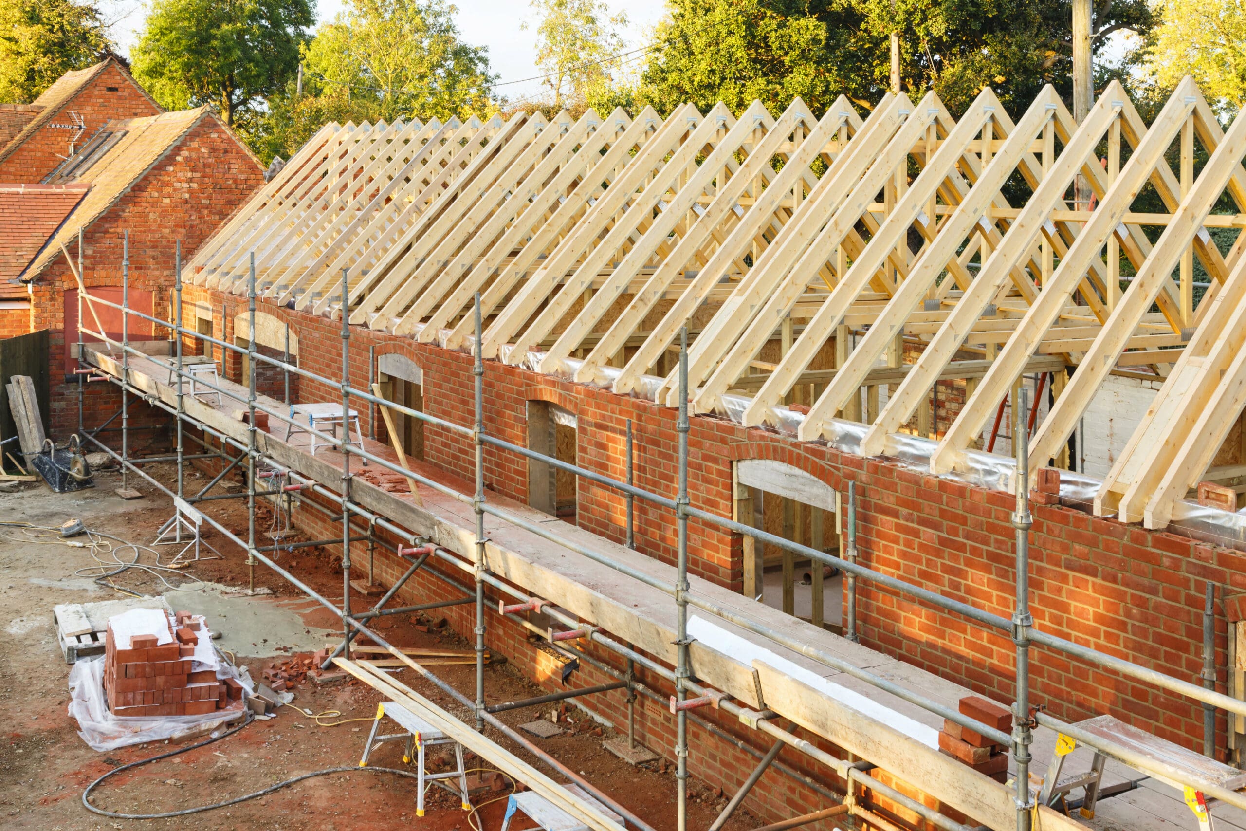 UK building site with scaffolding. Part of a period house is restored using modern building methods.